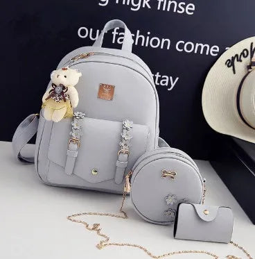 Women's 3-piece floral print PU leather bag set showing backpack, shoulder bag, and card purse in pink.