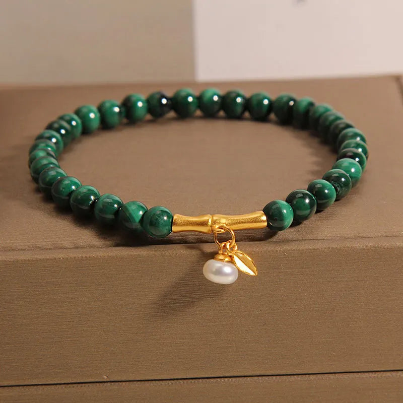 Women's white crystal lucky bamboo bracelet with adjustable clasp on a wrist.