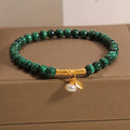 Women's white crystal lucky bamboo bracelet with adjustable clasp on a wrist.