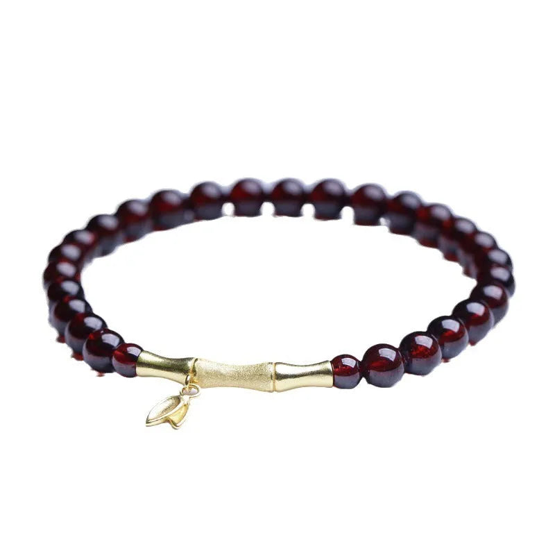 Natural garnet stone set in a 6mm wide bamboo joint bracelet with copper or silver metal finish.
