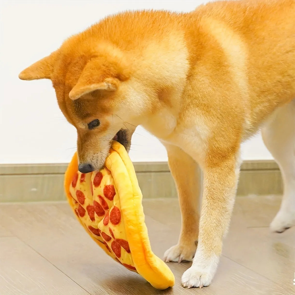 Yellow pizza slice shaped squeaky dog chew toy made from soft teddy fabric.