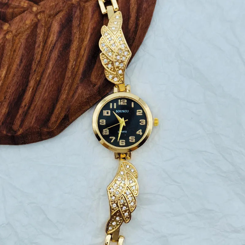 Stainless steel women's wristwatch with a round dial and vachette clasp, showing a gold-coloured surface.