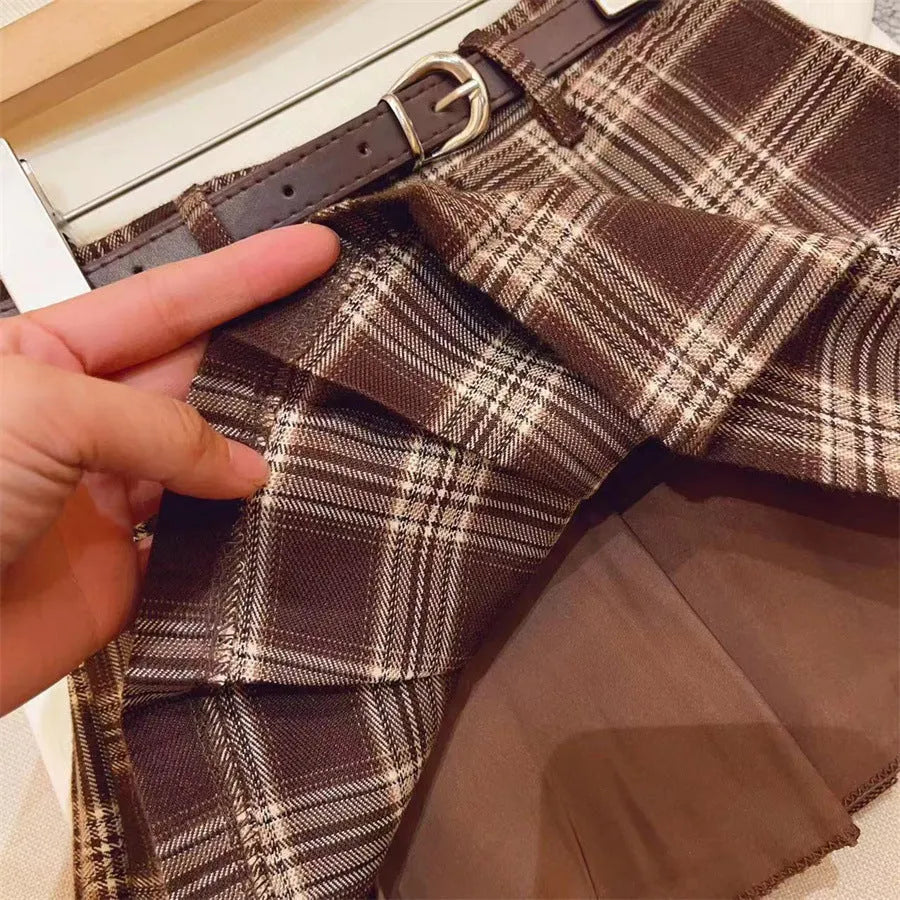 Girls' red and black plaid pleated A-line skirt on a hanger