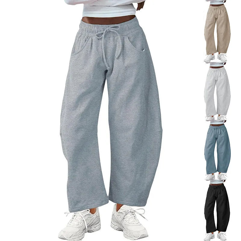 Loose fit cropped sweatpants in apricot colour with drawstring waist and side pockets on a neutral background.