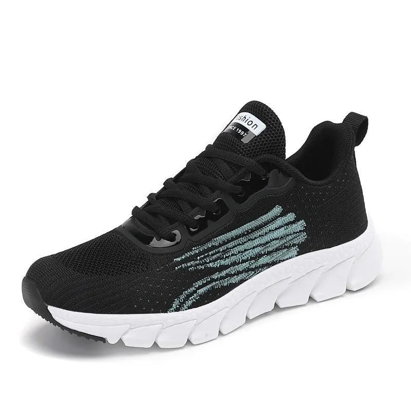 Women's black and white running shoes with cross strap detail and MD shock absorption sole