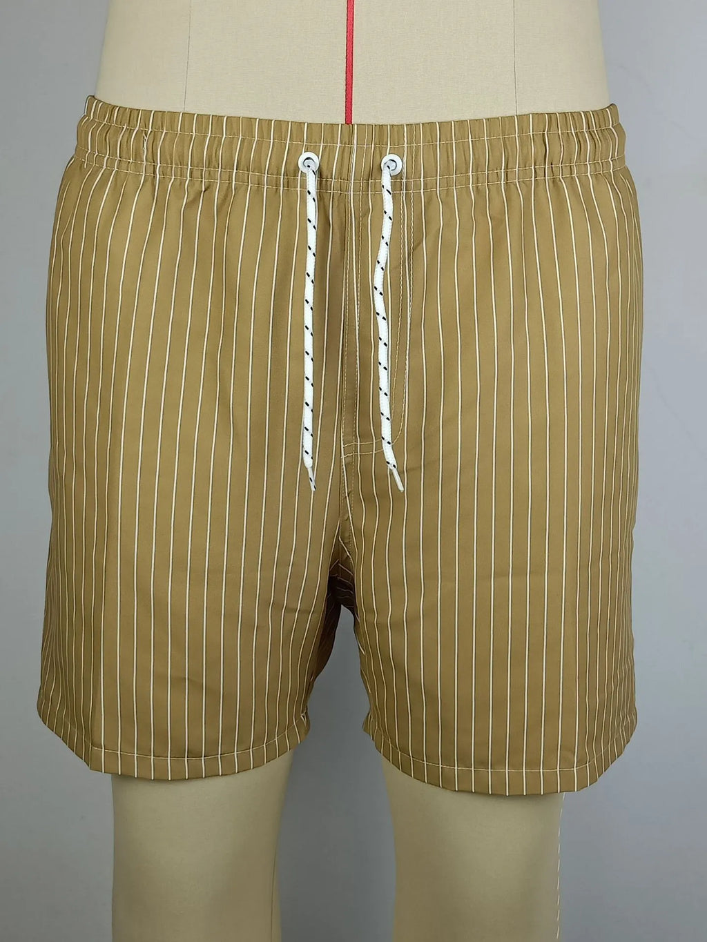 Polyester fibre striped beach shorts with triangle lining in navy blue, straight leg opening
