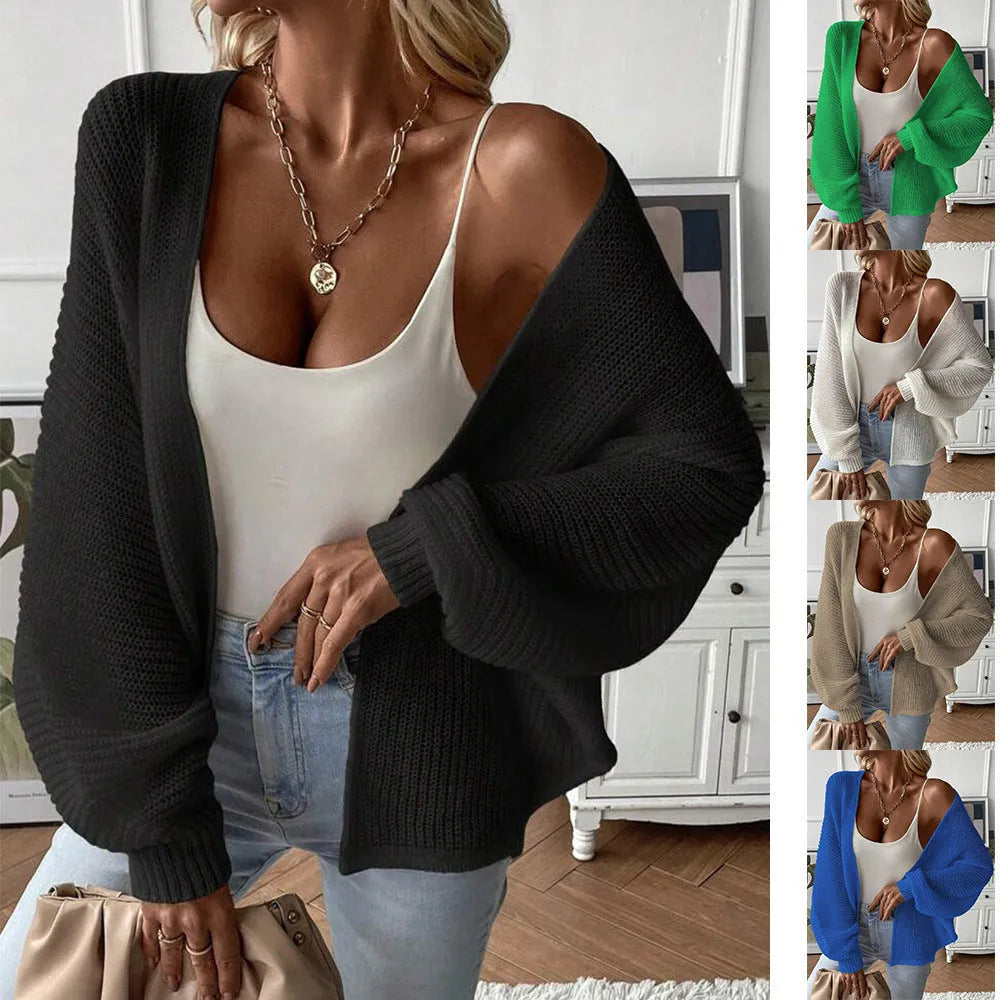 Loose-fitting women's cardigan with batwing sleeves in a solid colour, shown on a model.