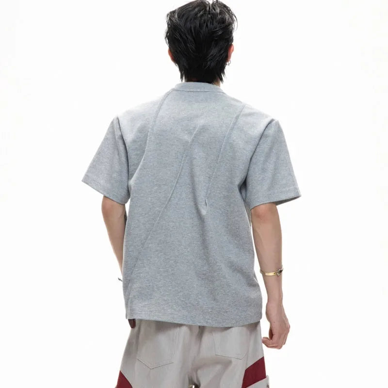 Men's black cotton t-shirt with three-dimensional pleats and asymmetric stitching on a loose fit.