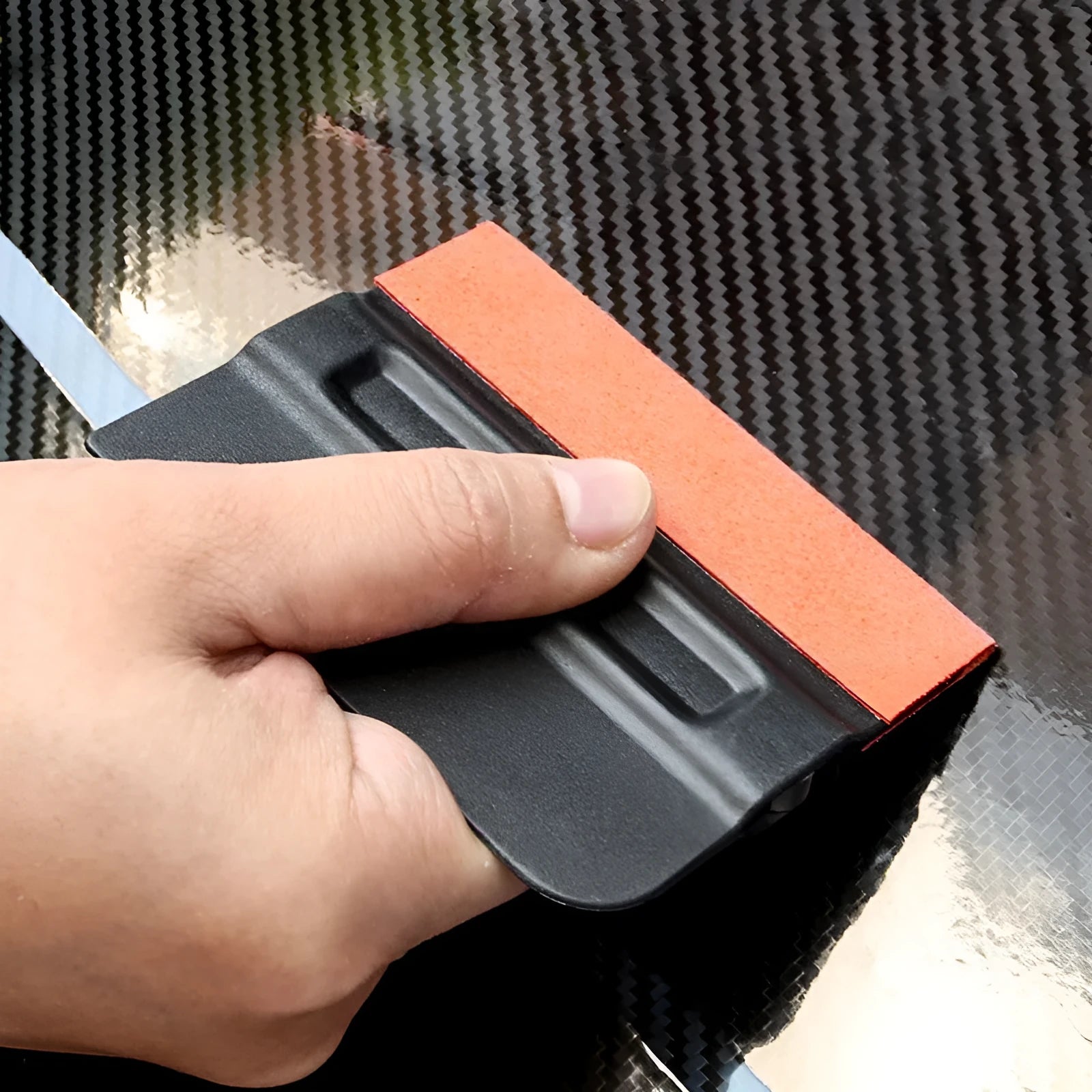 Car film application scraper tool with magnetic head and ABS handle on a work surface.