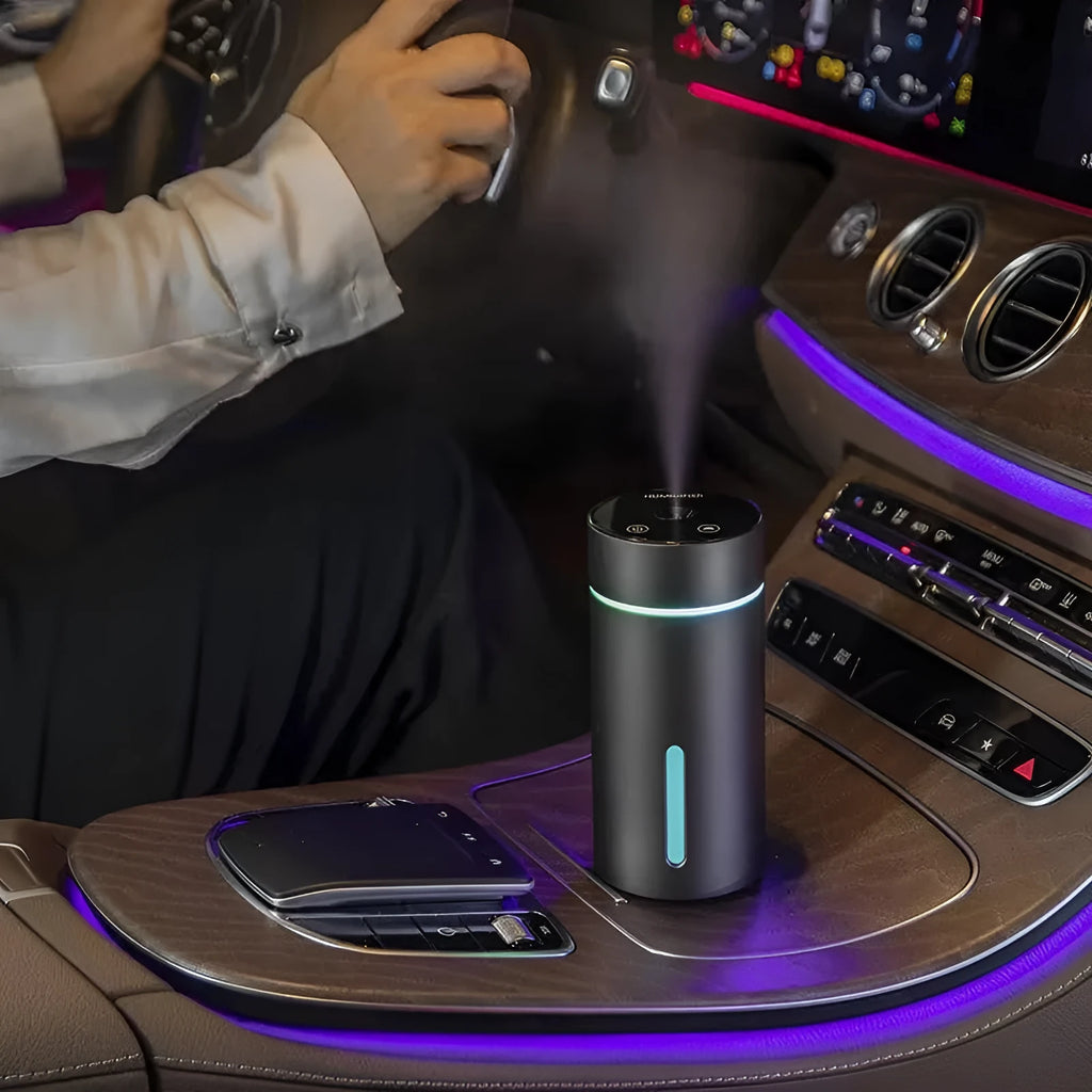 Black aluminium portable car humidifier and essential oil diffuser with night light on a desk
