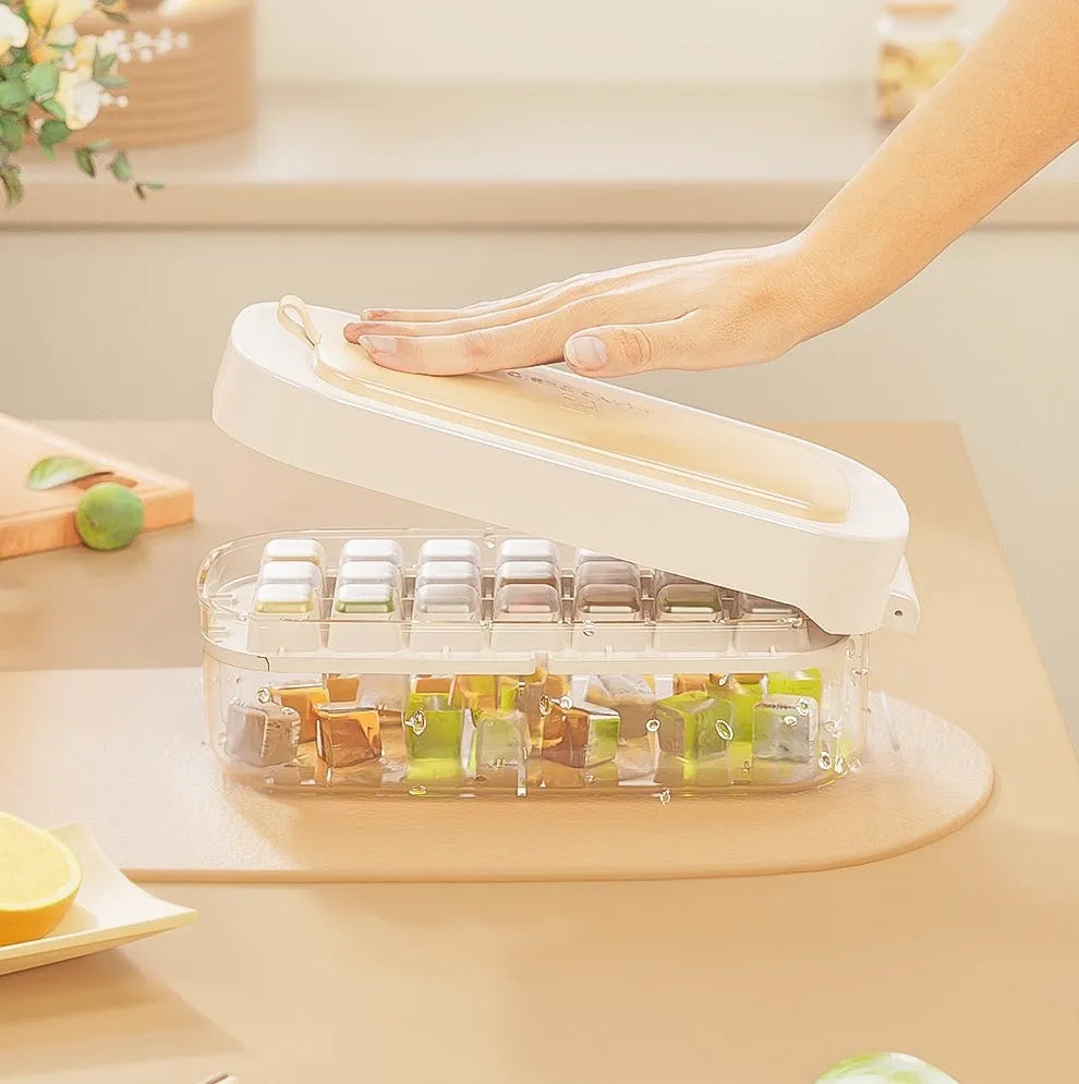 Food-grade high-capacity ice cube tray grid in blue with included ice shovel stored in dedicated slot.