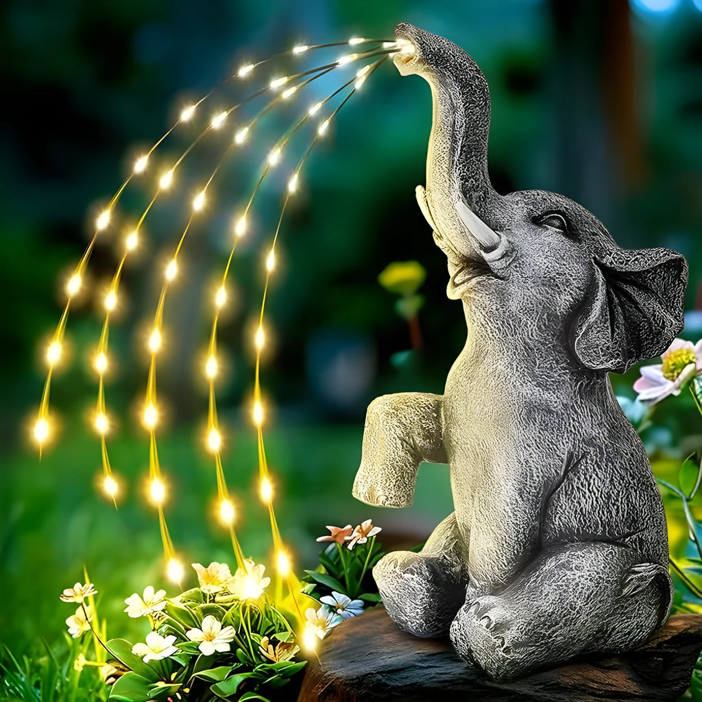 Grey resin elephant garden sculpture with solar panel and LED lights for outdoor decoration.