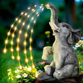 Grey resin elephant garden sculpture with solar panel and LED lights for outdoor decoration.