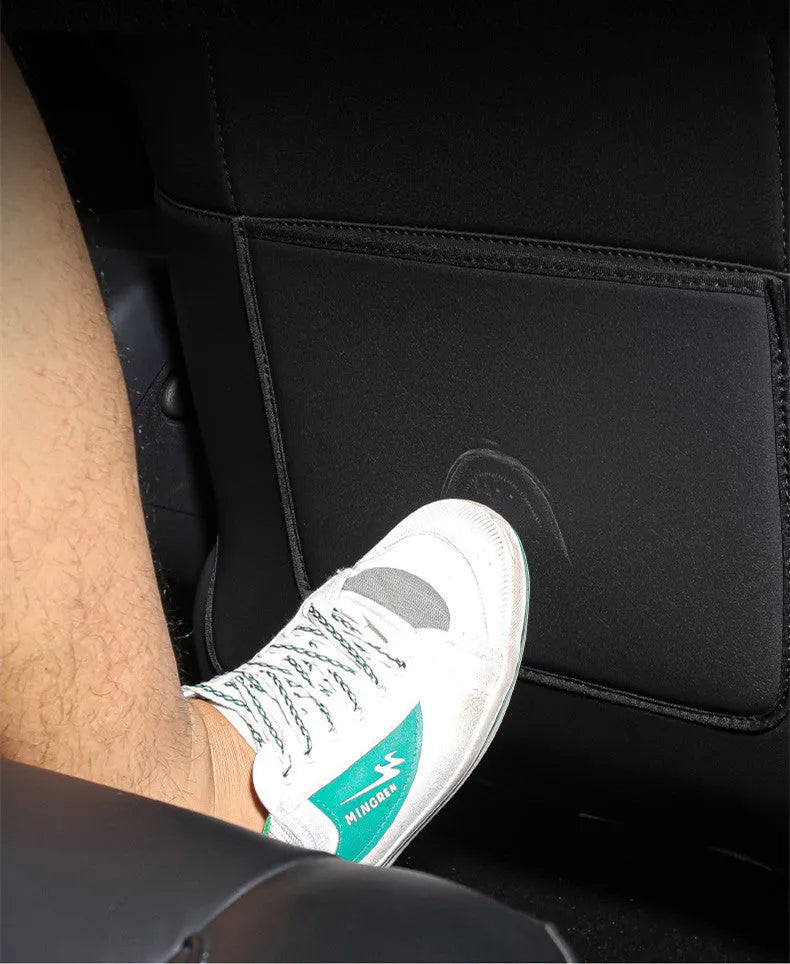 Black leather rear anti kick pad for car seat protection with a pocket.