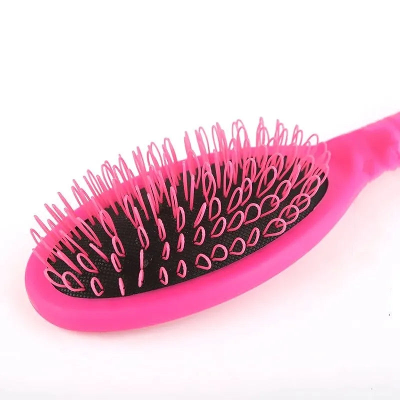 Black and pink ring tooth airbag comb for hair extensions, 22cm long.