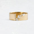 Women's gold-coloured ring with a shining zircon stone on a copper band.