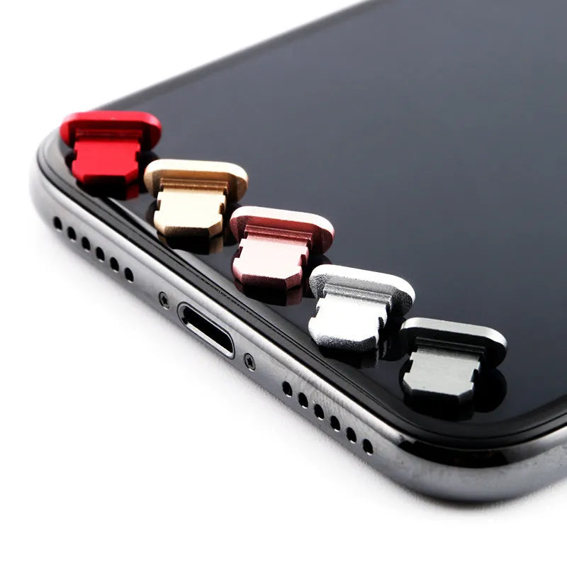 Aluminium alloy iPhone charging port dust plug shown in gold, silver, and rose gold colours.