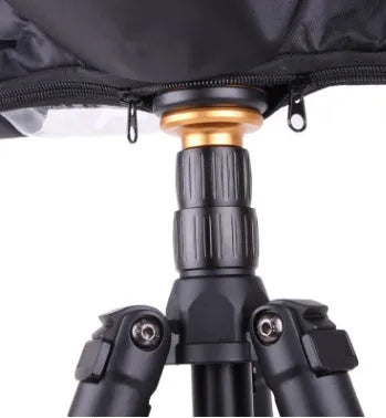 Black DSLR camera rain cover with elastic edges protecting long lens from rainfall