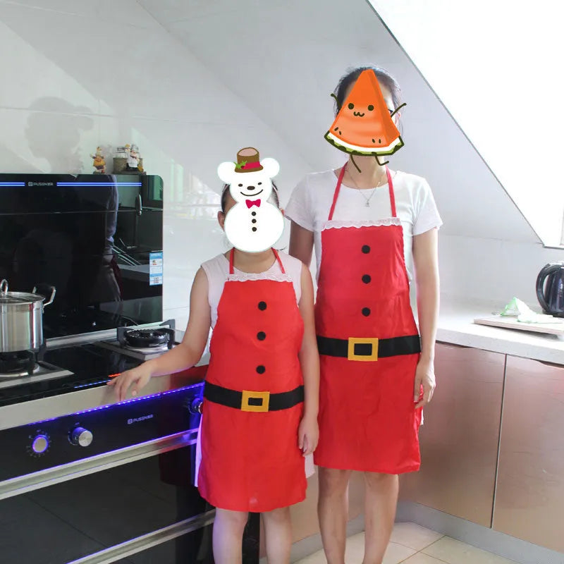 Red polyester Christmas apron with Merry Christmas text, shown in adult and children's sizes.