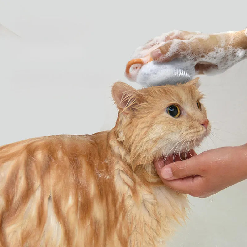 Orange TPR pet bath brush with shampoo dispenser and silicone bristles for dog and cat grooming