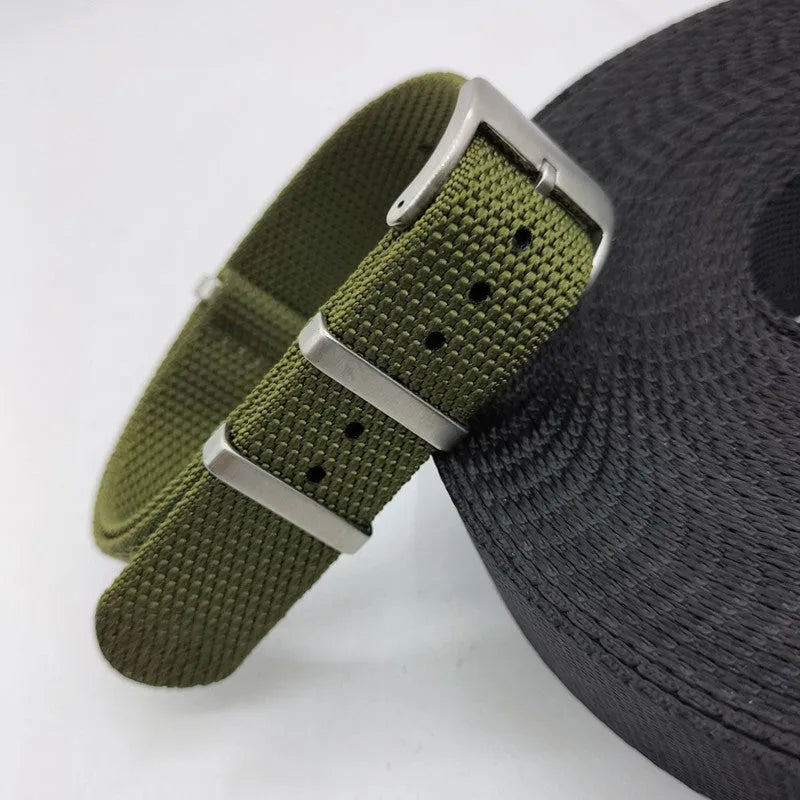 Nylon textile watch strap in army green colour with metal buckle, shown alongside black and blue options.