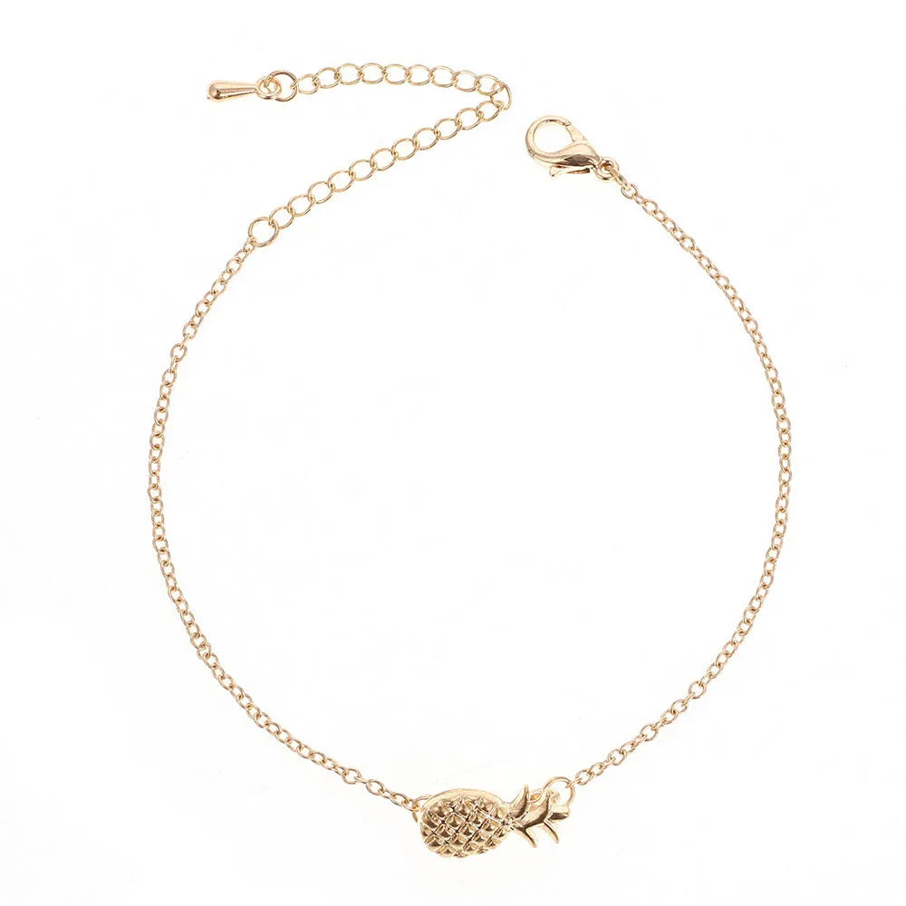 Women's gold tone alloy bracelet with a detailed pineapple charm on an adjustable chain.