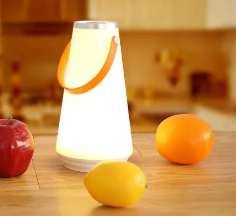 White USB rechargeable LED bedside night light with touch control on a wooden table.