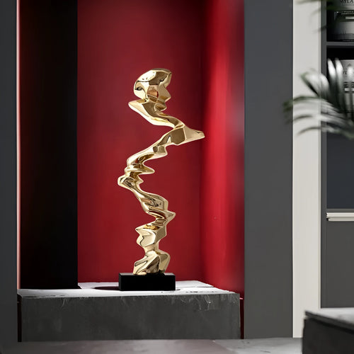 Minimalist abstract still life ornament in natural resin on a shelf, shown in bright gold finish.