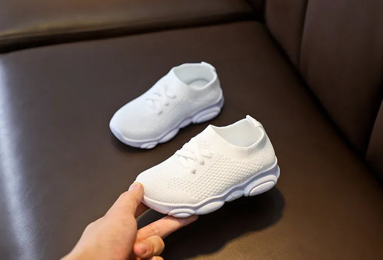Children's fabric lazy shoes in white, black, pink, and grey colours with non-slip rubber sole