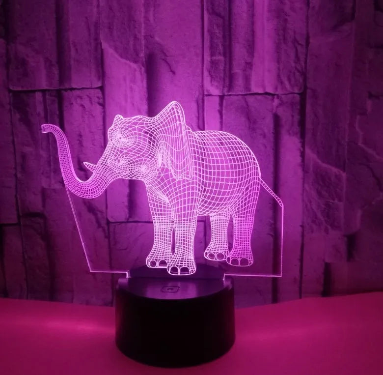 3D LED elephant touch lamp showing seven colour modes on a wooden desk