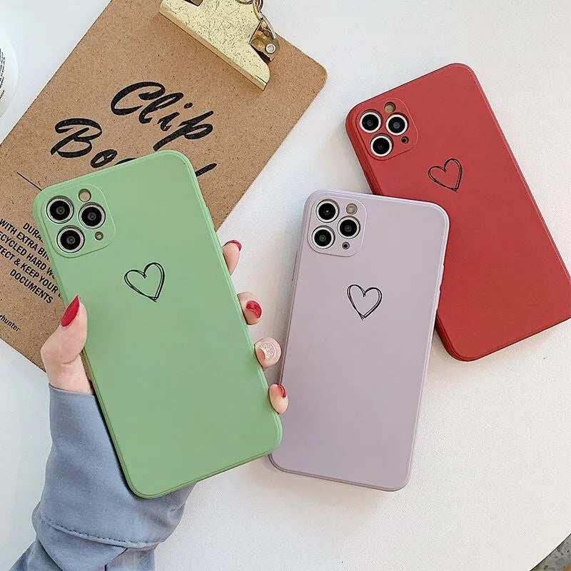 Silicone phone case for Apple iPhone in multiple solid colour options including black, pink, and purple