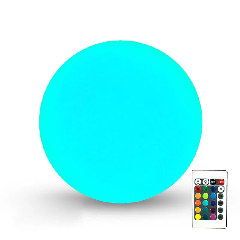 Remote control LED ball-shaped lawn lamp lit up with multi-colours on a garden patio.