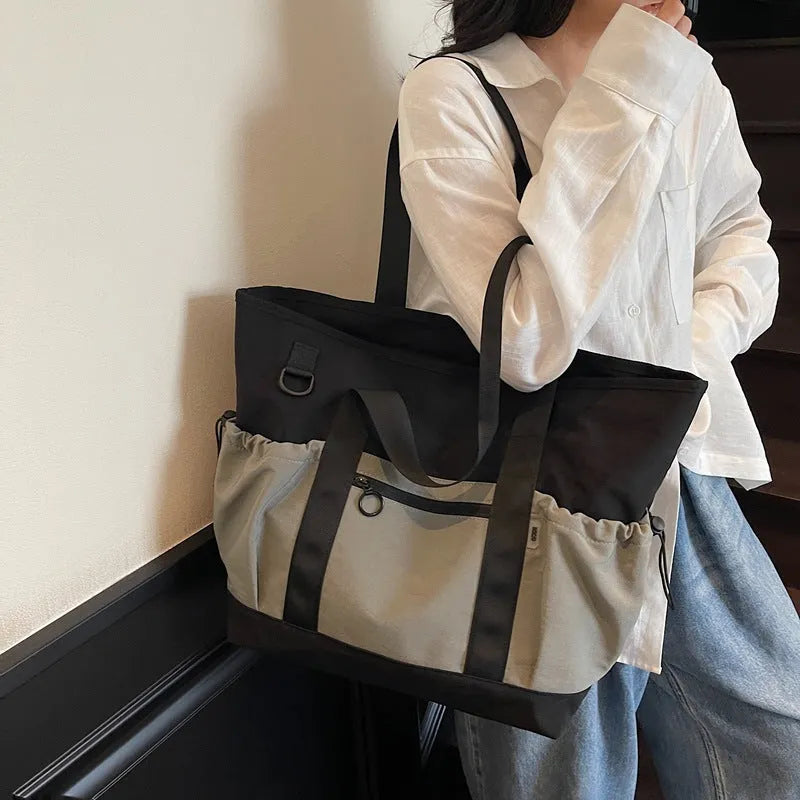 Women's lightweight oxford cloth travel bag in grey, black or green with 36-55L capacity