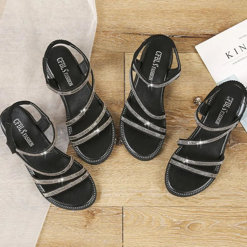Women's silver casual sandals with round toe, rhinestone details, elastic band, and flat rubber sole.