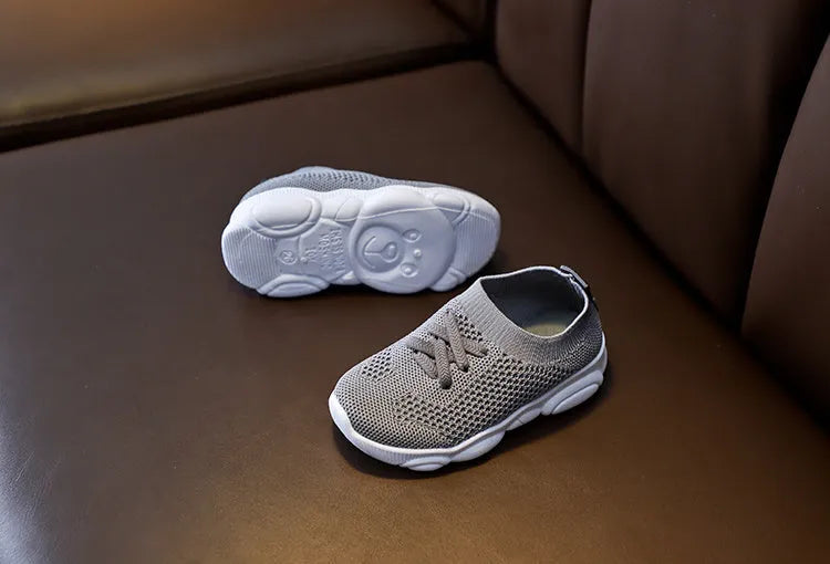 Children's fabric lazy shoes in white, black, pink, and grey colours with non-slip rubber sole