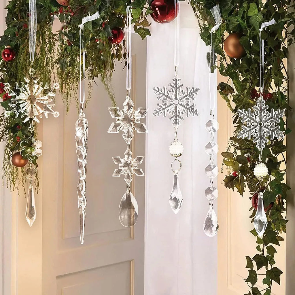 Ten clear transparent acrylic ice cone Christmas tree ornaments with white ribbons on green branches.