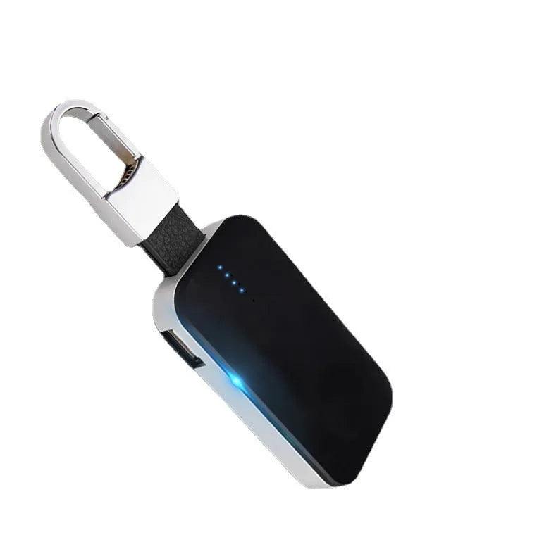 Black keychain-sized wireless power bank for Apple Watch on a keyring.