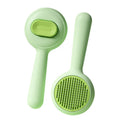 Green and yellow cat brush with stainless steel comb teeth and non-slip handle for pet grooming.