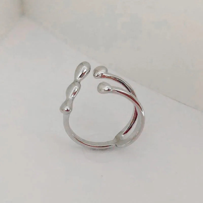 Brass spherical ring with circular design elements in gold or silver finish