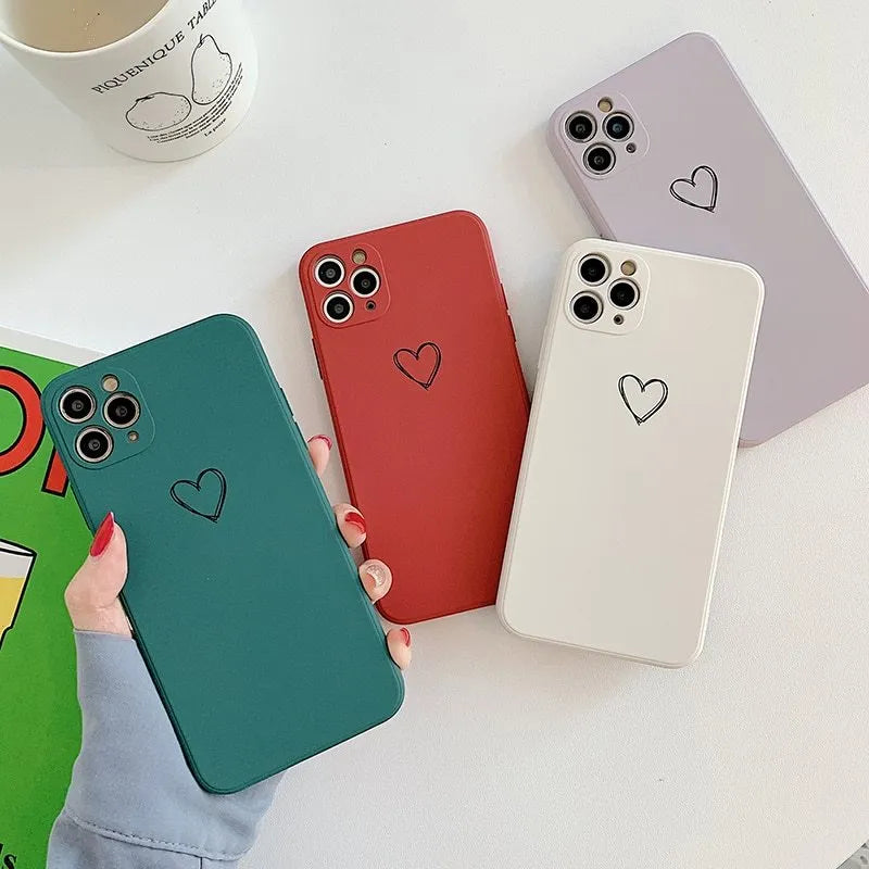 Silicone phone case for Apple iPhone in multiple solid colour options including black, pink, and purple