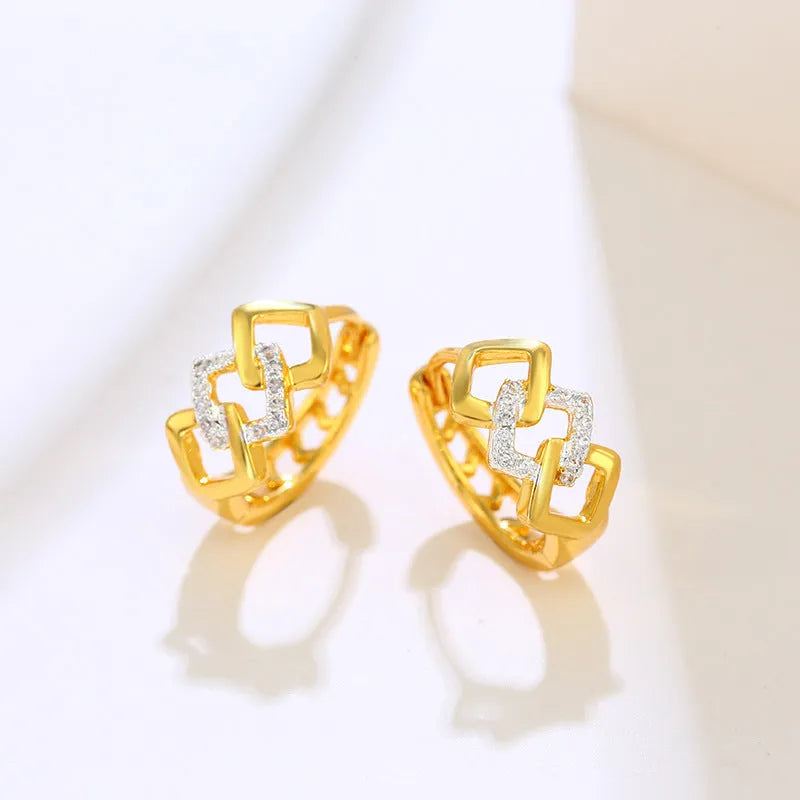 Gold geometric hollow out alloy earrings with ear clip fastening shown from front angle