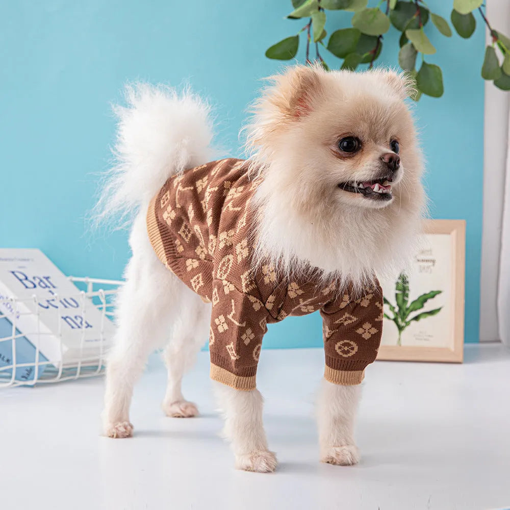 A dog wearing a thick, knitted wool sweater in a choice of monochrome or two-tone colours.
