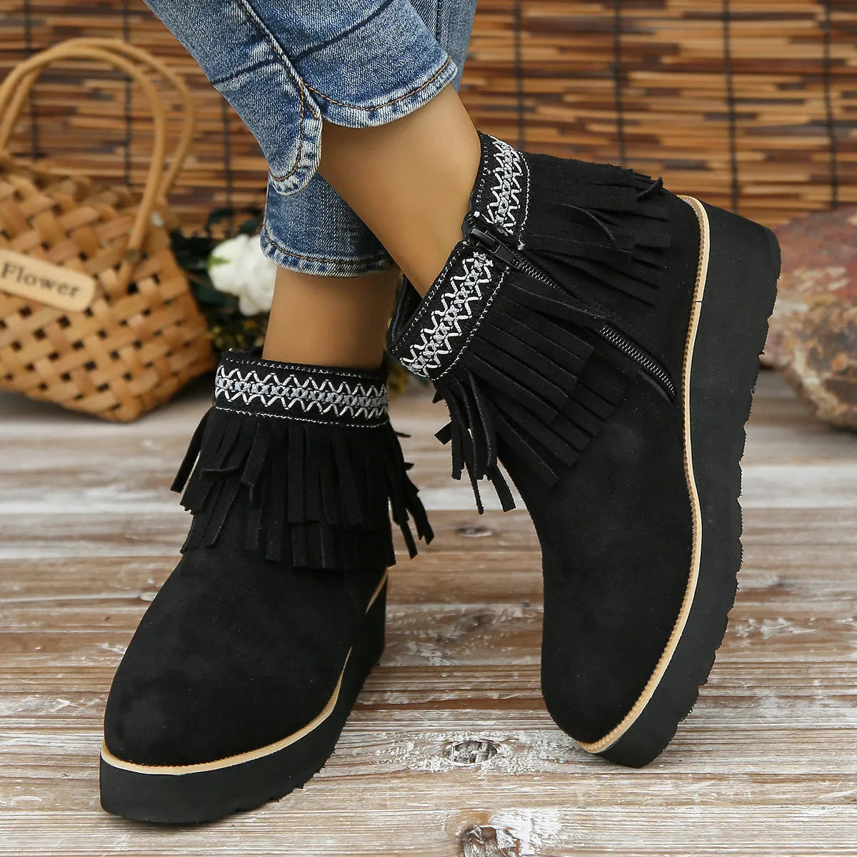 Women's dark brown suede wedge ankle boots with side zip and tassel detail on a thick rubber sole.