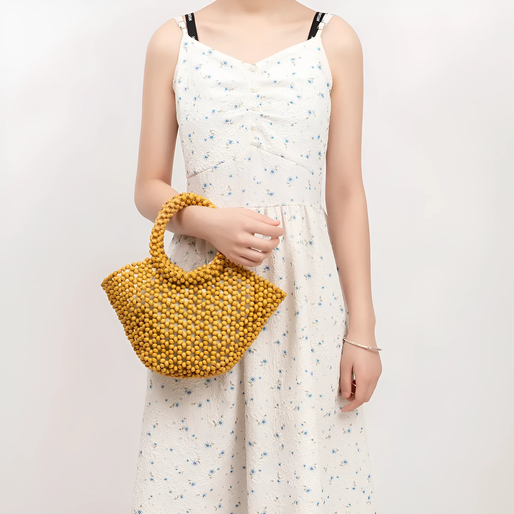 Hand-woven maple beach handbag with wooden beads in dumpling shape, shown in milky white colour