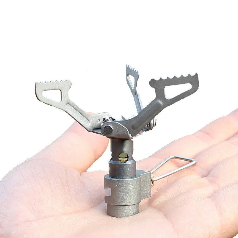 Portable propane gas camping stove with a one-piece burner unit.