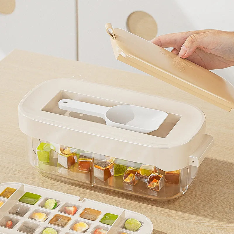 Food-grade high-capacity ice cube tray grid in blue with included ice shovel stored in dedicated slot.