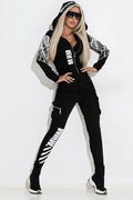 Black women's hooded tracksuit with wings print, featuring a zip-front top and matching trousers.