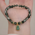 Women's citrine and chorite crystal bracelet with green ghost calabash pendant and heart charm.