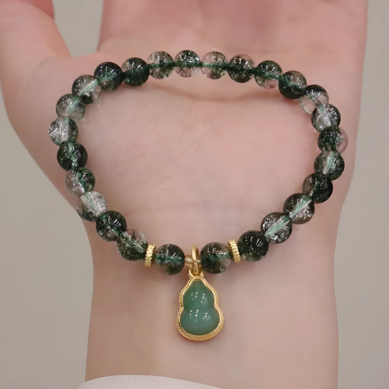 Women's citrine and chorite crystal bracelet with green ghost calabash pendant and heart charm.