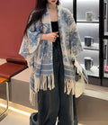 Women's polyester scarf cape with tassel trim in a colourful photographic print design.